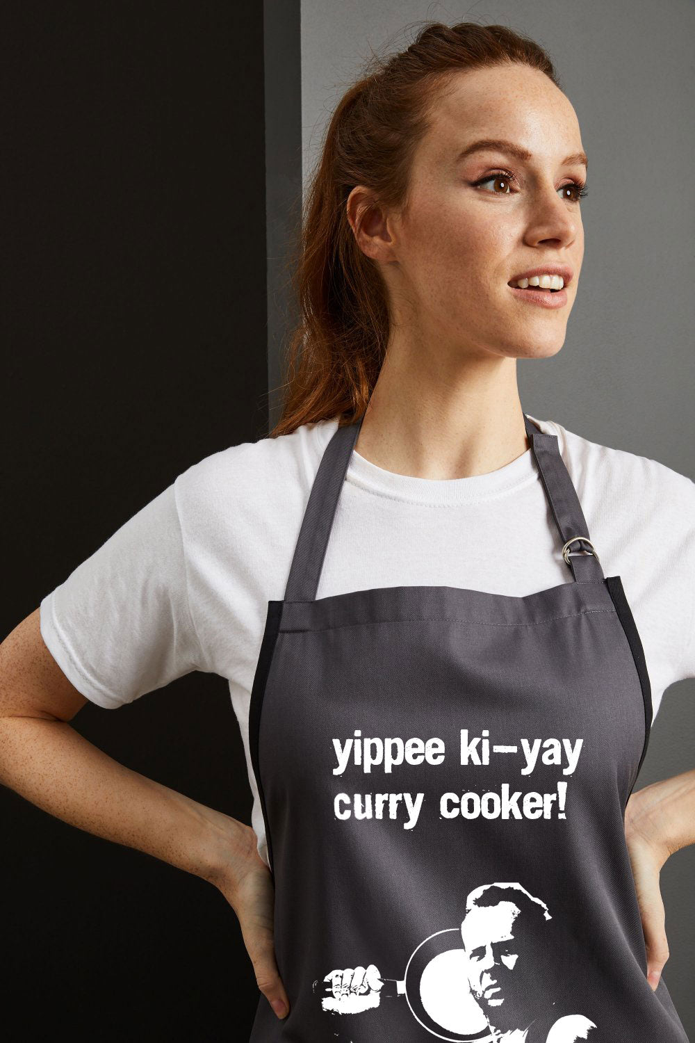 Yippee ki-yay Curry Cooker! Bruce Willis Charcoal Coloured Apron with Boom Kitchen logo Super Close Up